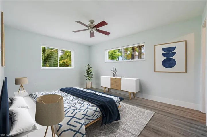 Bedroom featuring ceiling fan and dark wood-type flooring