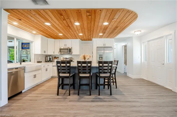 Dining area featuring wooden ceiling and light hardwood / wood-style flooring