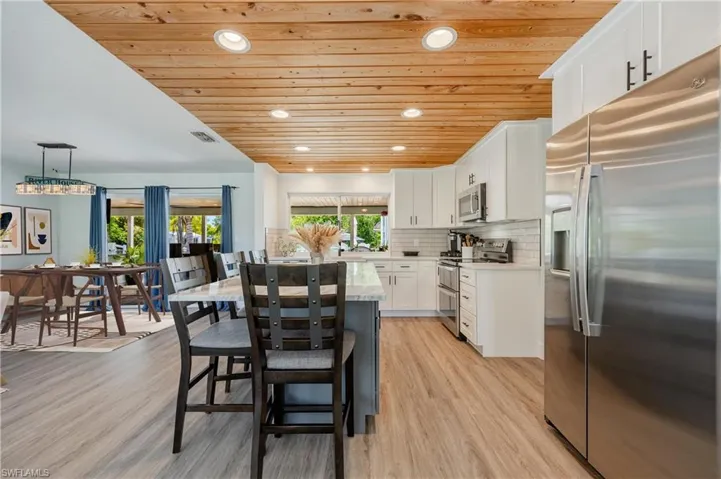 Kitchen with appliances with stainless steel finishes, white cabinetry, and light wood-type flooring