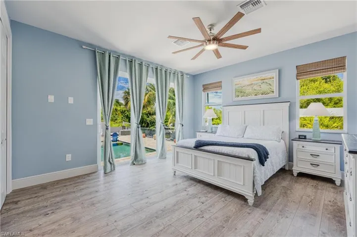Bedroom featuring access to outside, light hardwood / wood-style floors, and ceiling fan