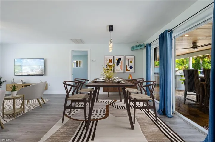 Dining room with ceiling fan and wood-type flooring