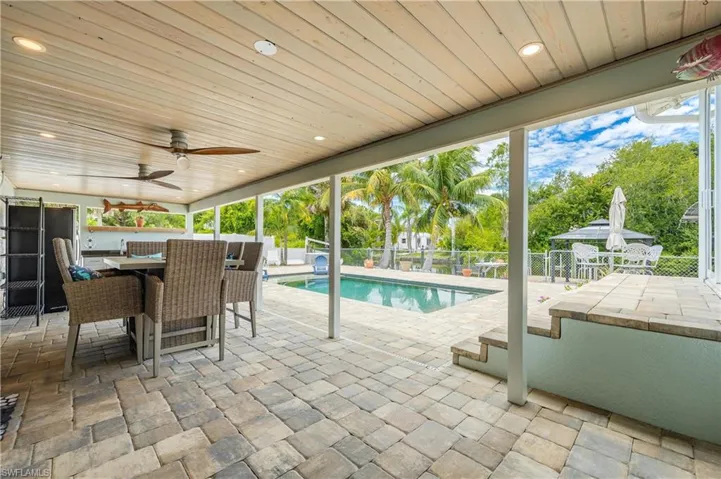 View of swimming pool featuring a patio and ceiling fan
