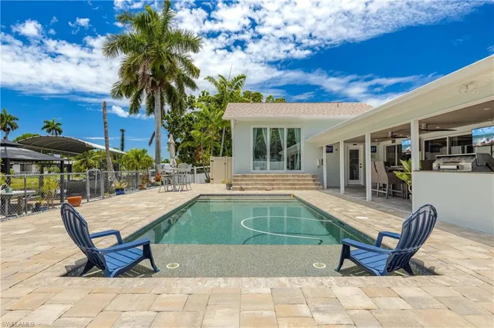 View of pool with a patio area, ceiling fan, and french doors