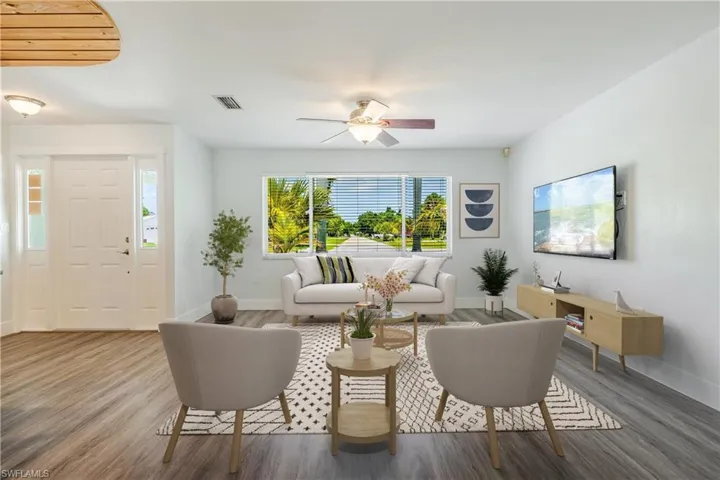 Living room featuring hardwood / wood-style flooring and ceiling fan