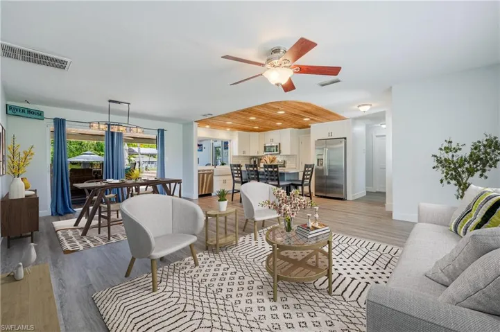 Living room with ceiling fan and light wood-type flooring