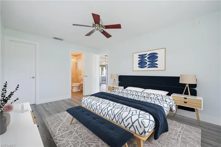Bedroom with connected bathroom, ceiling fan, and hardwood / wood-style floors