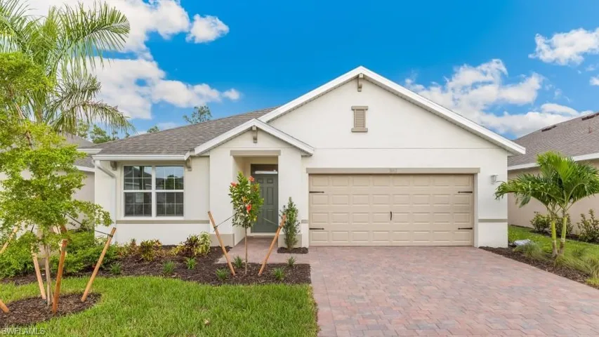 Model home. Ranch-style house with stucco siding, decorative driveway, an attached garage, and roof with shingles