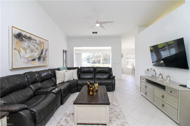 Living room featuring ceiling fan and light tile patterned floors