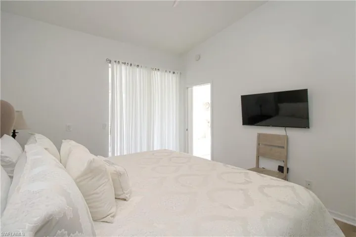 Bedroom featuring lofted ceiling