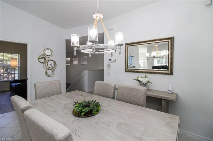 Dining space featuring tile patterned floors and an inviting chandelier