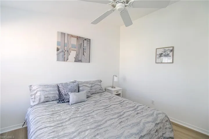 Bedroom with light hardwood / wood-style floors and ceiling fan