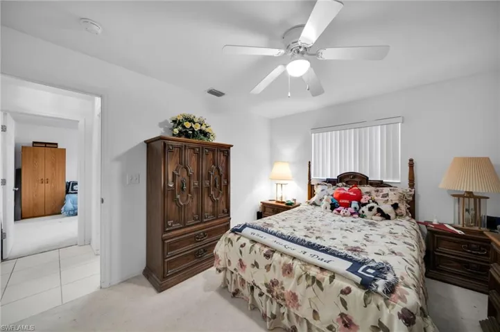 Bedroom featuring light colored carpet and a ceiling fan