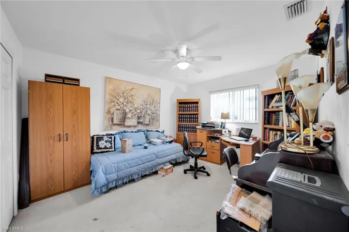 Office area featuring light carpet and ceiling fan