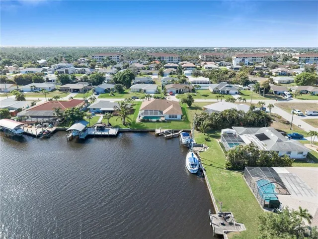 Aerial overview of property's location with a large body of water and nearby suburban area