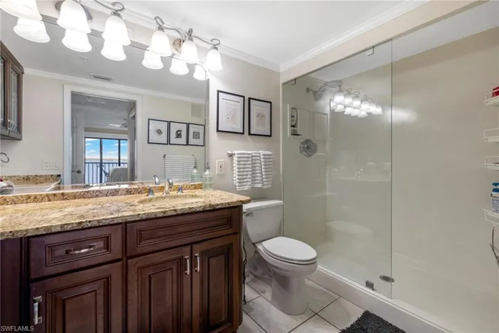 Newly finished marble shower with stationary glass partition