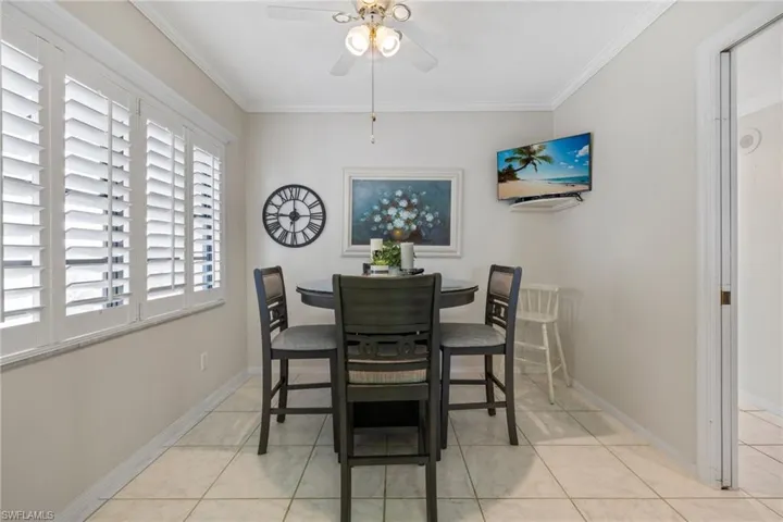 Eat-in breakfast nook in the kitchen with ample light from the custom shutters