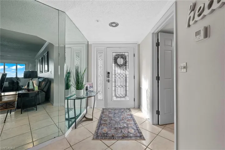 Tiled entrance foyer with custom mirrors.  Laundry room just off the foyer.