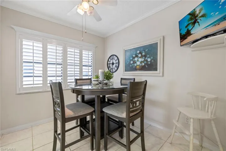 Eat-in breakfast nook in the kitchen with ample light from the custom shutters