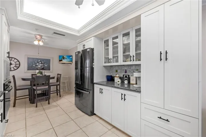Built-in coffee bar with glass pane cabinets.  Adjacent large pantry with roll out drawers.