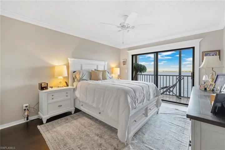 Primary bedroom with new wood flooring and private balcony