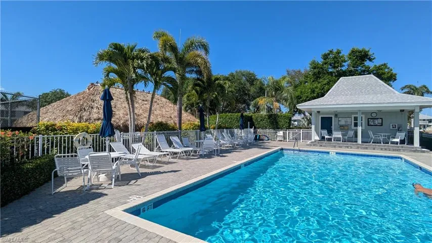 Pool with a patio and fence