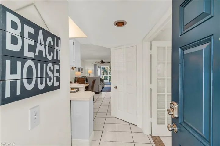 Foyer with ceiling fan and light tile patterned floors