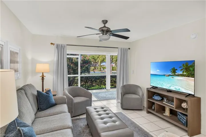 Furnished Living area with light tile patterned flooring and ceiling fan
