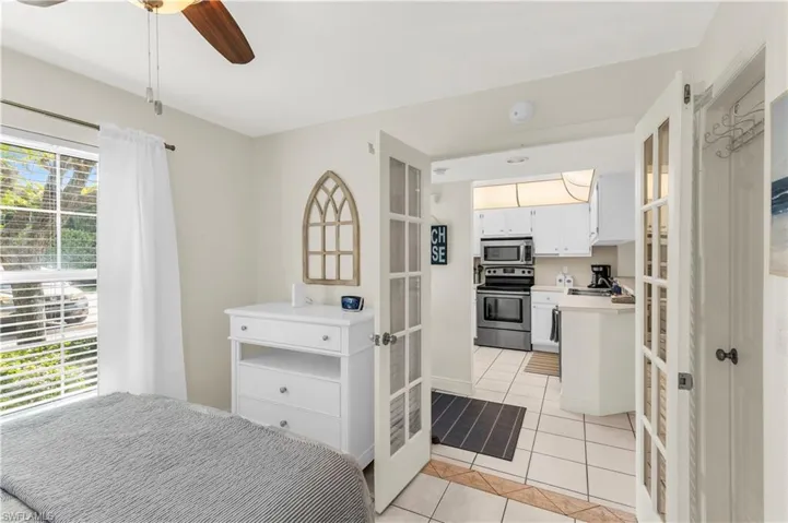 Guest Bedroom, ceiling fan and light tile patterned floors