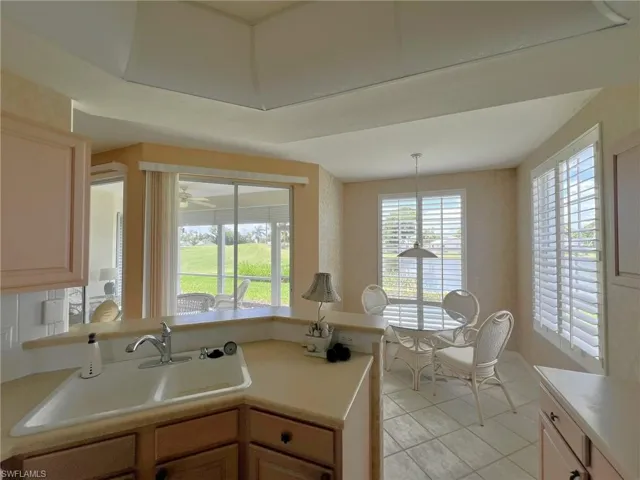 Kitchen with a healthy amount of sunlight, sink, light brown cabinets, and light tile patterned floors