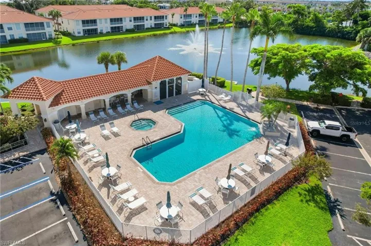 View of swimming pool featuring a patio and a water view