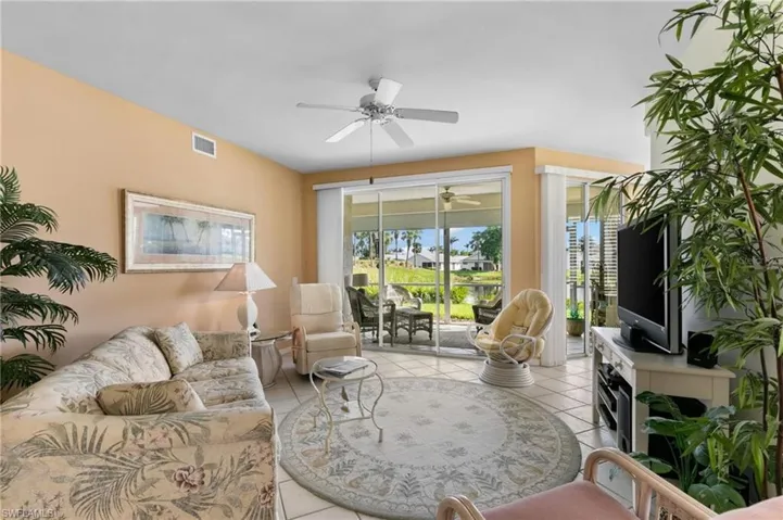Living room featuring ceiling fan and light tile patterned floors