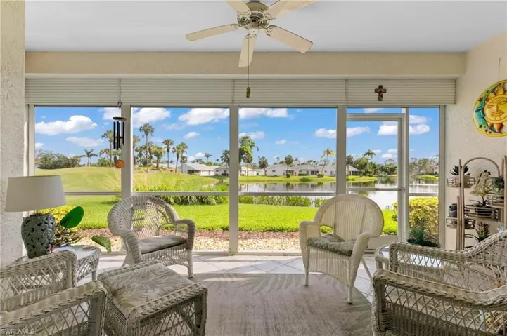 Sunroom / solarium featuring a water view, ceiling fan, and a healthy amount of sunlight