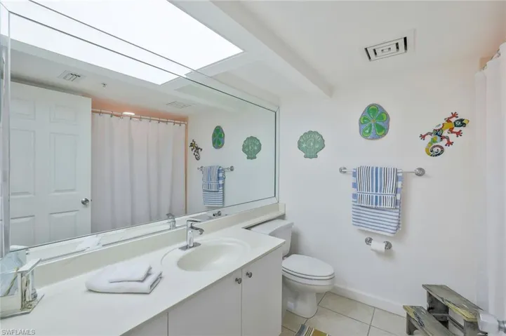 Full bath with vanity and tile patterned floors