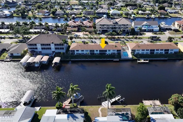 Aerial view of residential area featuring a nearby body of water