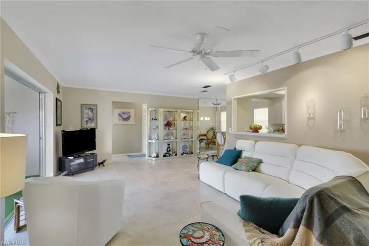 Living room with track lighting and a ceiling fan