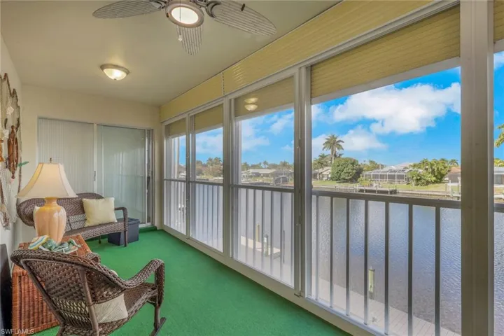 Sunroom with a water view and carpet floors