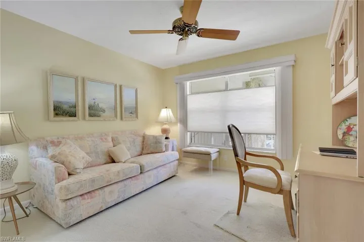 Living room with carpet and ceiling fan
