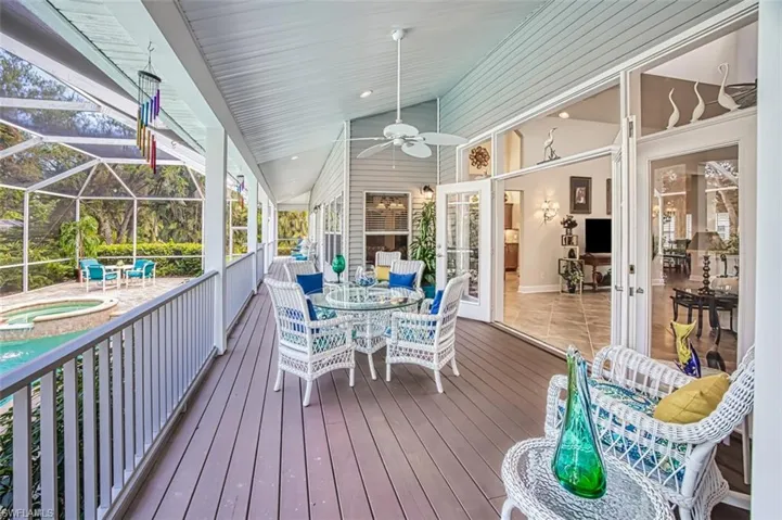 Rear Porch overlooking the pool with hot tub, and ceiling fan
