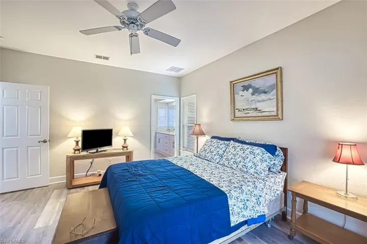 Second bedroom featuring hardwood / wood-style flooring and ceiling fan