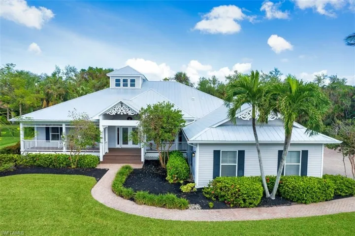 View of front of property with a porch and a front lawn