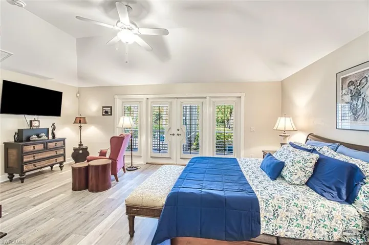 Bedroom featuring hardwood / wood-style flooring, ceiling fan, lofted ceiling, french doors, and access to outside
