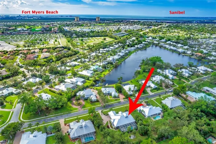 Birds eye view of property with a water view