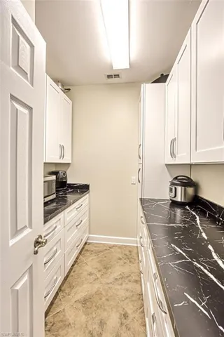 Kitchen featuring white cabinets