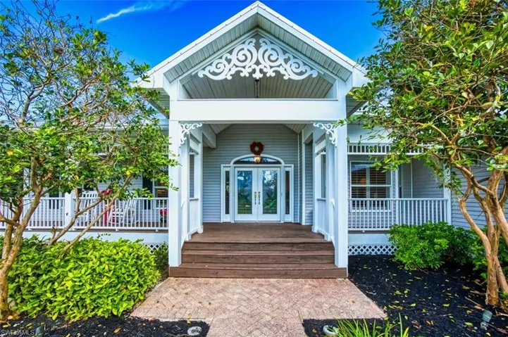 View of exterior entry with a porch and french doors