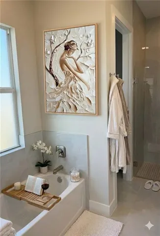 Full bathroom featuring a stall shower, a bath, and light tile patterned floors