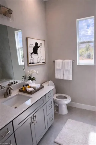 Full bathroom featuring toilet and vanity