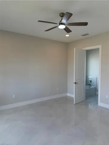 Unfurnished bedroom featuring baseboards and a ceiling fan