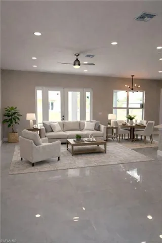 Living room featuring recessed lighting and a ceiling fan