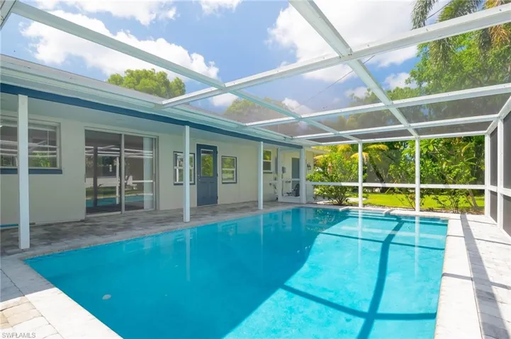 Outdoor pool with a patio and a lanai