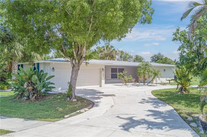 Ranch-style house with an attached garage, stucco siding, and concrete driveway